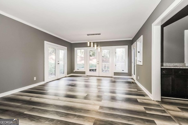 spare room with ornamental molding, dark wood-type flooring, and french doors