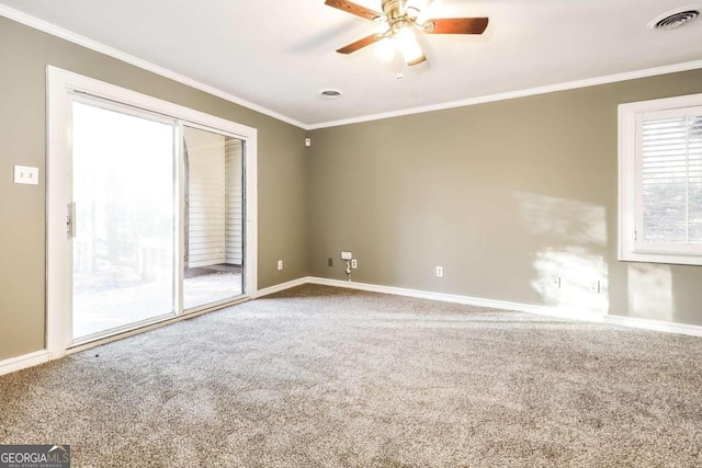 empty room with carpet flooring, ceiling fan, and crown molding