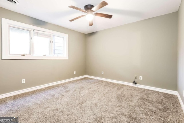 spare room featuring carpet and ceiling fan