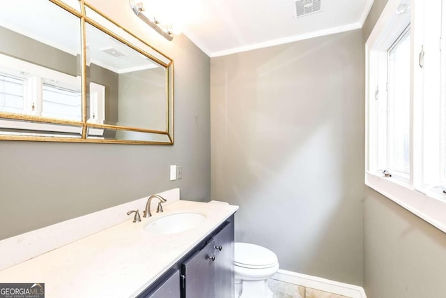 bathroom featuring vanity, ornamental molding, and toilet