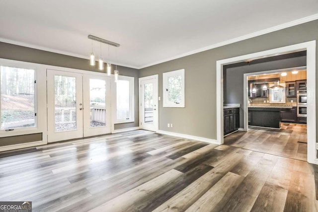 interior space with crown molding, dark wood-type flooring, and french doors