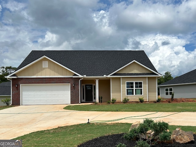 view of front of property featuring a garage and a front lawn