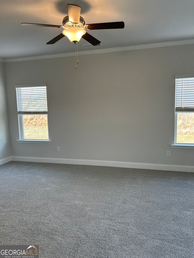 carpeted empty room with a wealth of natural light, ornamental molding, and ceiling fan