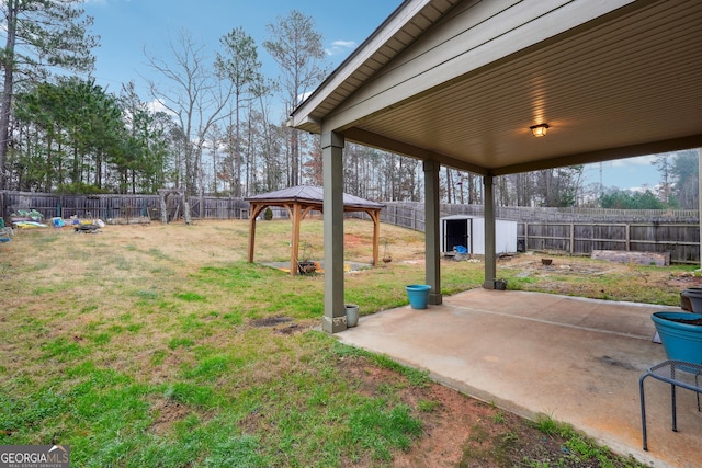 view of yard featuring a storage shed, a patio area, and a gazebo