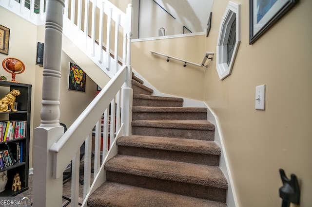 stairs featuring carpet