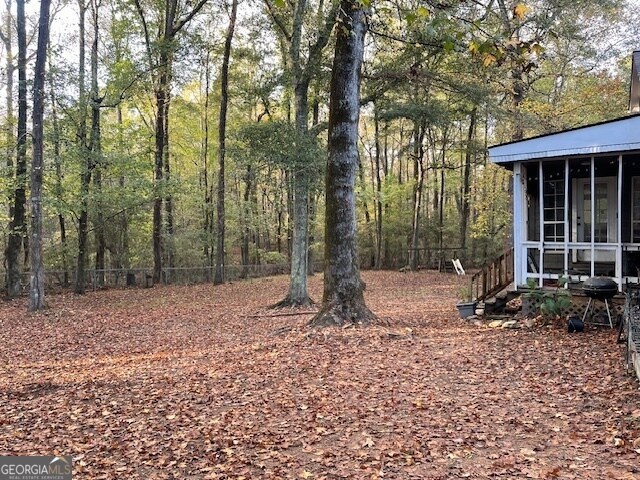 view of yard featuring a sunroom