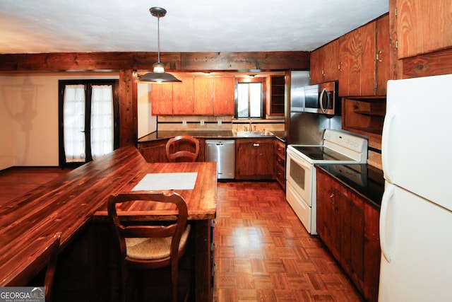 kitchen with french doors, sink, hanging light fixtures, stainless steel appliances, and dark parquet floors