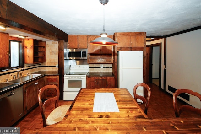 kitchen featuring appliances with stainless steel finishes, tasteful backsplash, dark parquet floors, sink, and decorative light fixtures