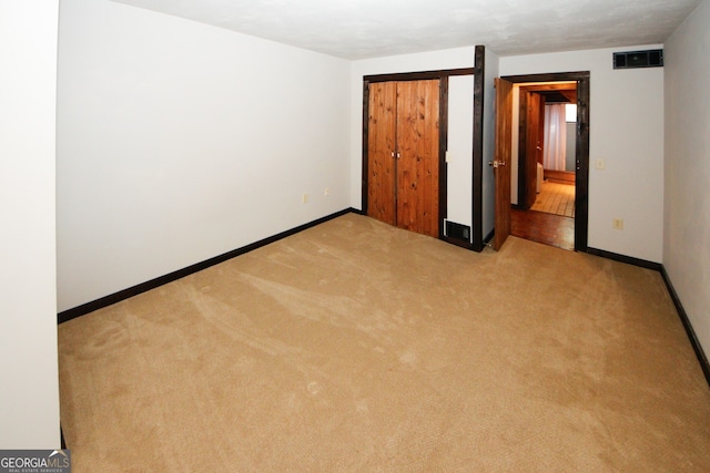 unfurnished bedroom with light colored carpet