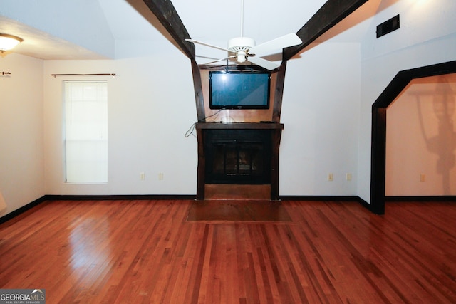 unfurnished living room with beamed ceiling, wood-type flooring, and ceiling fan