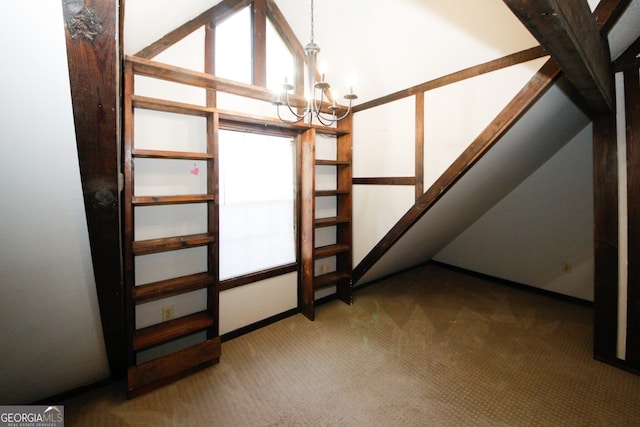 interior space featuring carpet floors, a chandelier, and lofted ceiling