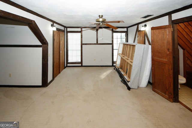 interior space featuring crown molding, ceiling fan, and light colored carpet