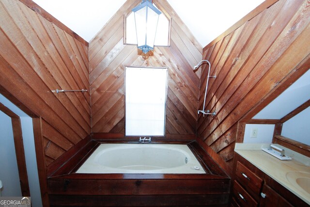 bathroom featuring a tub to relax in and sink