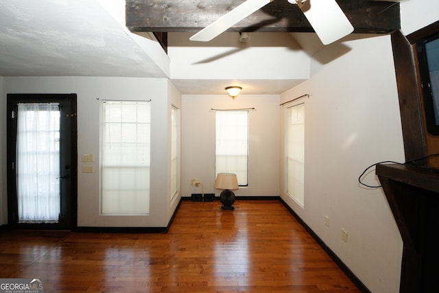 interior space with ceiling fan and dark wood-type flooring