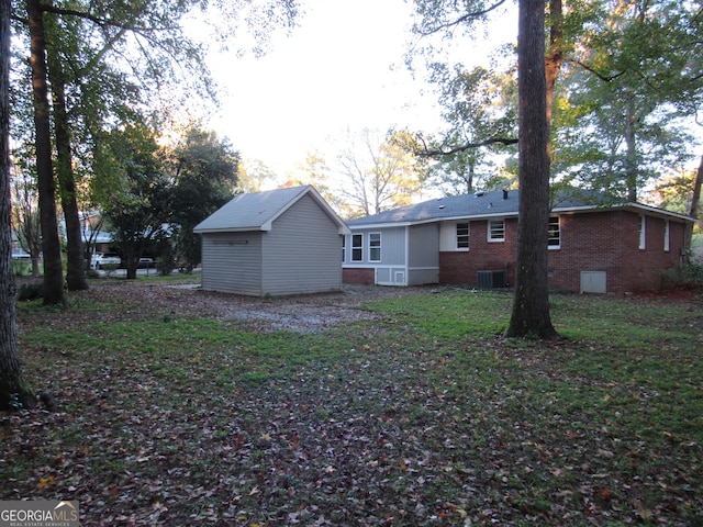 rear view of house featuring central AC