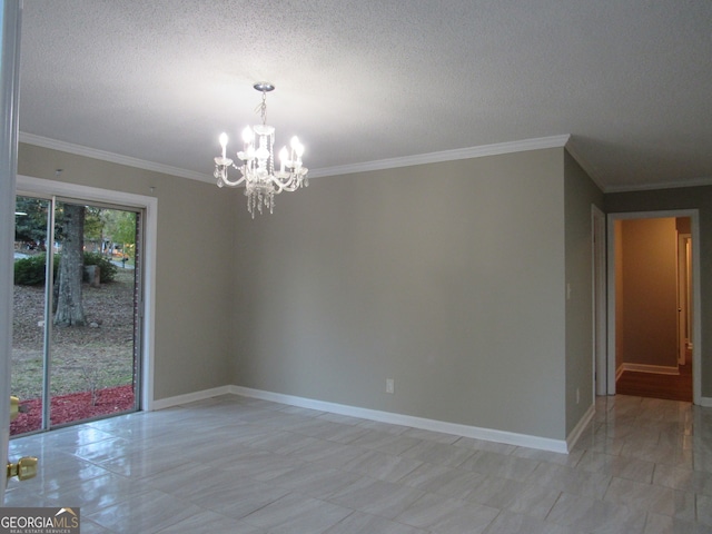 spare room featuring a textured ceiling, an inviting chandelier, and ornamental molding