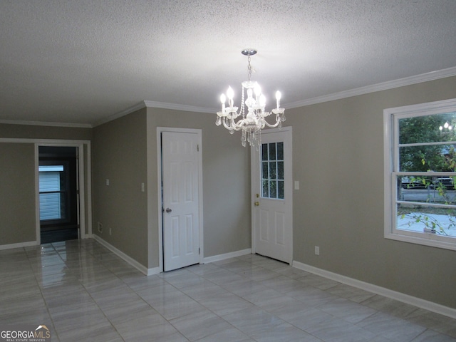 unfurnished dining area with a textured ceiling, crown molding, and a notable chandelier