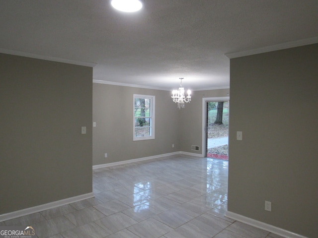 tiled spare room with crown molding, a chandelier, and a textured ceiling