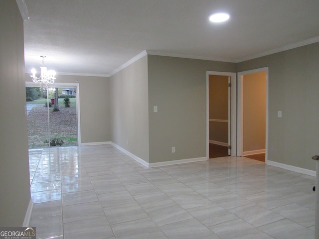 empty room featuring a notable chandelier and ornamental molding