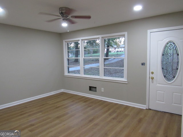 foyer entrance with ceiling fan and wood-type flooring