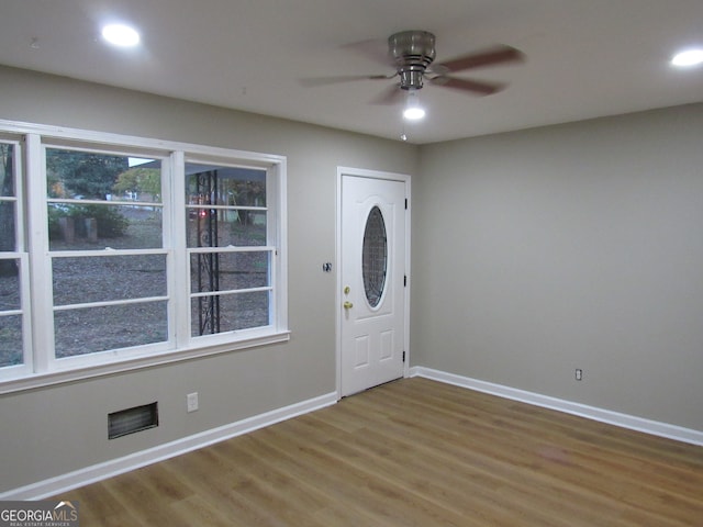 entryway with ceiling fan and wood-type flooring