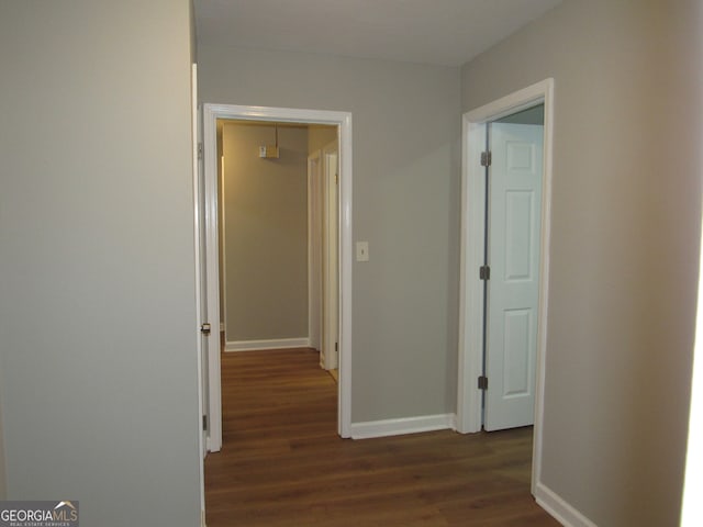 hallway featuring dark hardwood / wood-style flooring