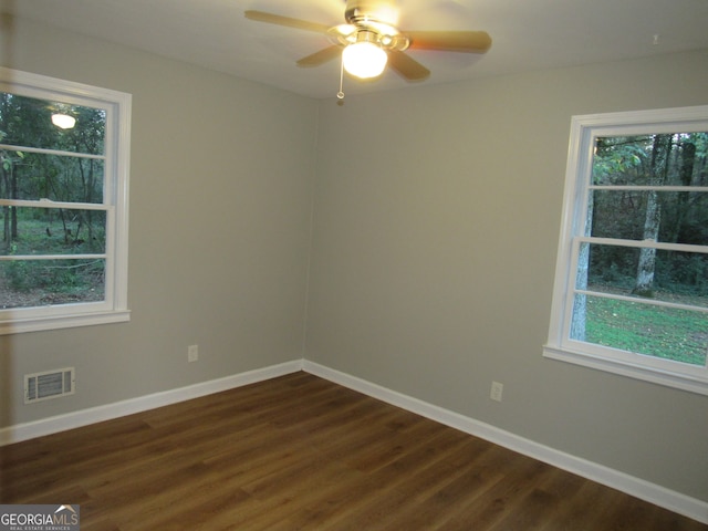 spare room with ceiling fan and dark wood-type flooring