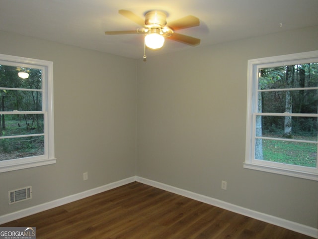 unfurnished room with ceiling fan and dark hardwood / wood-style floors