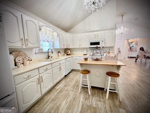 kitchen featuring white cabinets, white appliances, and sink