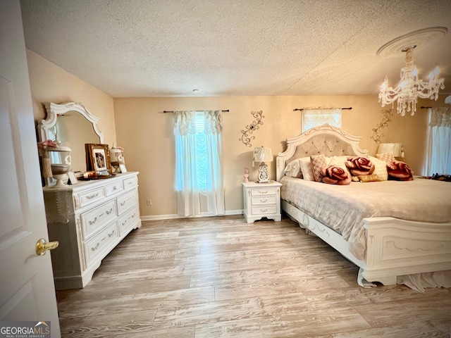 bedroom featuring a textured ceiling and light wood-type flooring