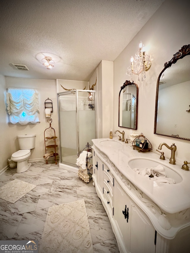 bathroom with vanity, a textured ceiling, toilet, and walk in shower