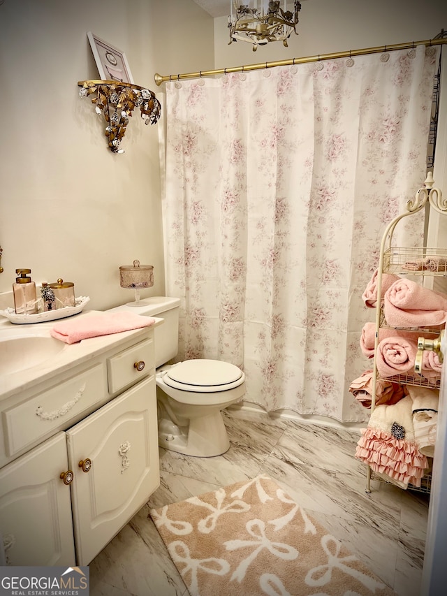 bathroom featuring vanity and toilet