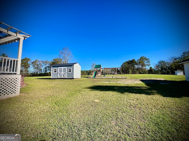 view of yard featuring a playground and a storage unit