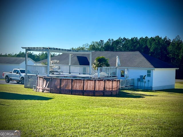 back of property featuring a swimming pool side deck and a yard