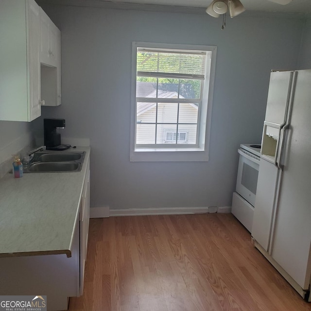 kitchen with white appliances, sink, ceiling fan, light wood-type flooring, and white cabinetry