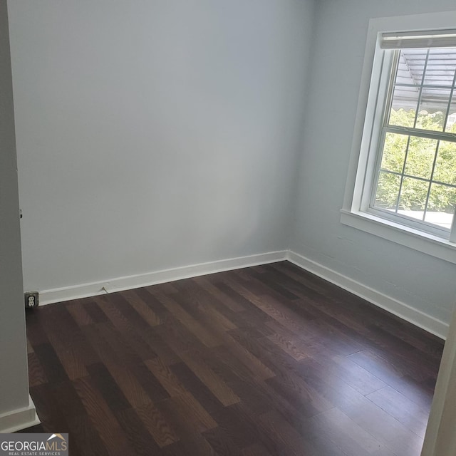 spare room with dark hardwood / wood-style floors