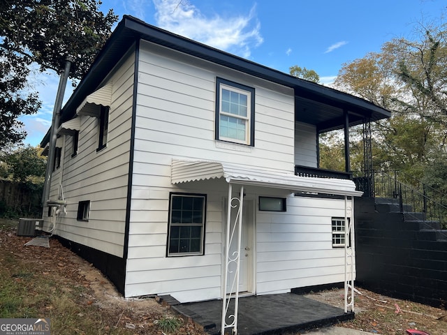 back of property featuring central air condition unit