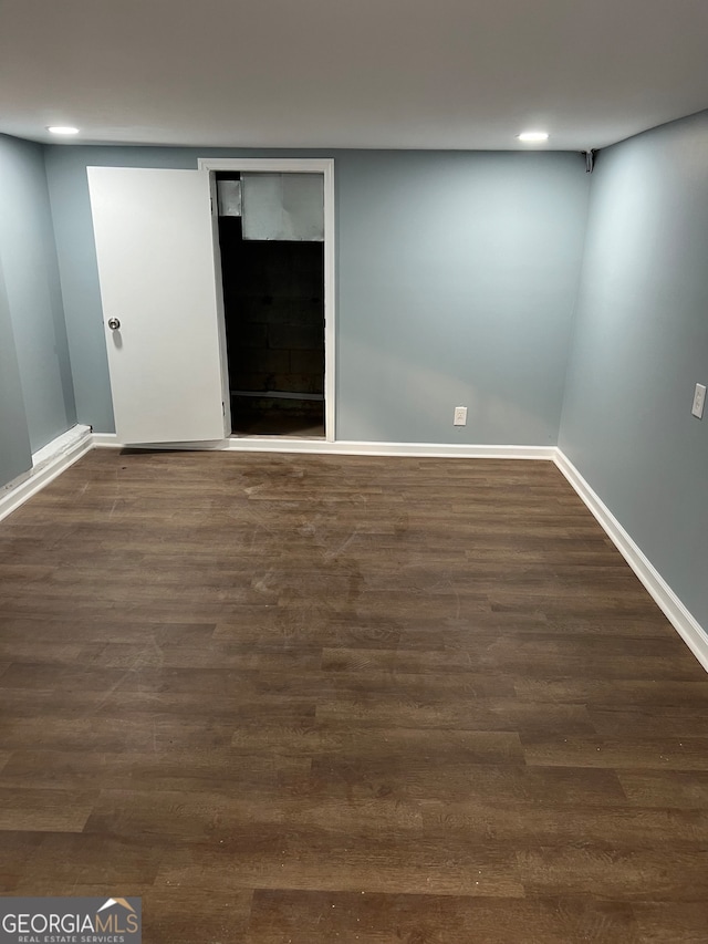 basement featuring dark hardwood / wood-style floors