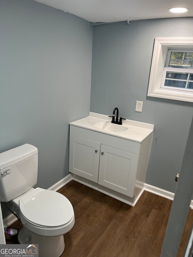 bathroom featuring hardwood / wood-style floors, vanity, and toilet