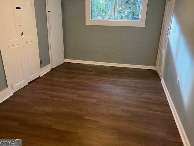 unfurnished bedroom with dark hardwood / wood-style floors