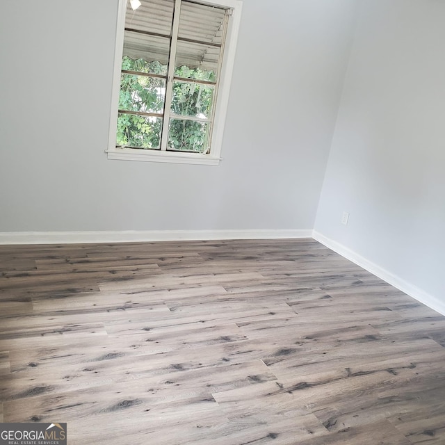 empty room with wood-type flooring