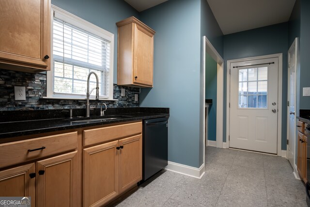 kitchen with black dishwasher, tasteful backsplash, a wealth of natural light, and dark stone counters