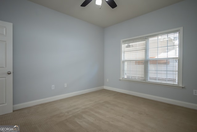 unfurnished room featuring ceiling fan and light colored carpet