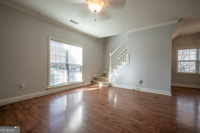 unfurnished living room featuring dark hardwood / wood-style floors, ceiling fan, and crown molding