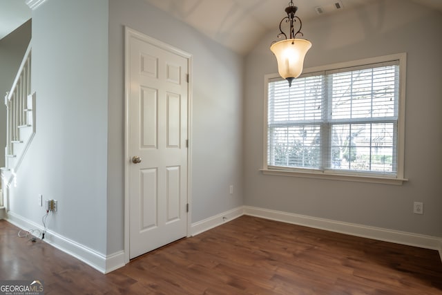 unfurnished room featuring dark hardwood / wood-style flooring and vaulted ceiling