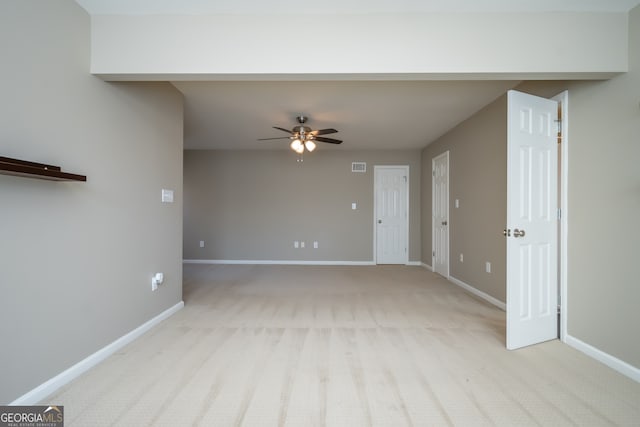 unfurnished living room featuring light carpet and ceiling fan