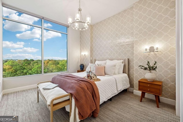 bedroom with carpet floors and a notable chandelier