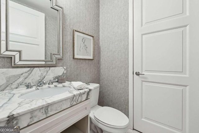 bathroom featuring backsplash, vanity, and toilet