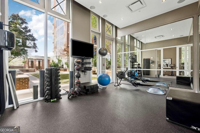 workout area featuring a high ceiling