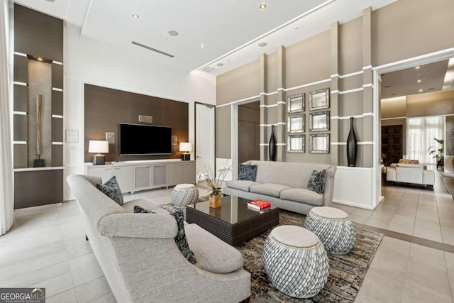 tiled living room with a towering ceiling